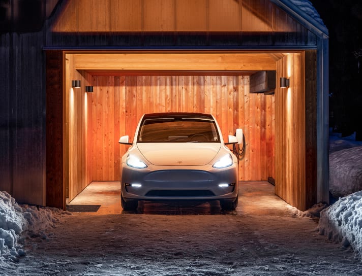 White Model Y parked in a garage