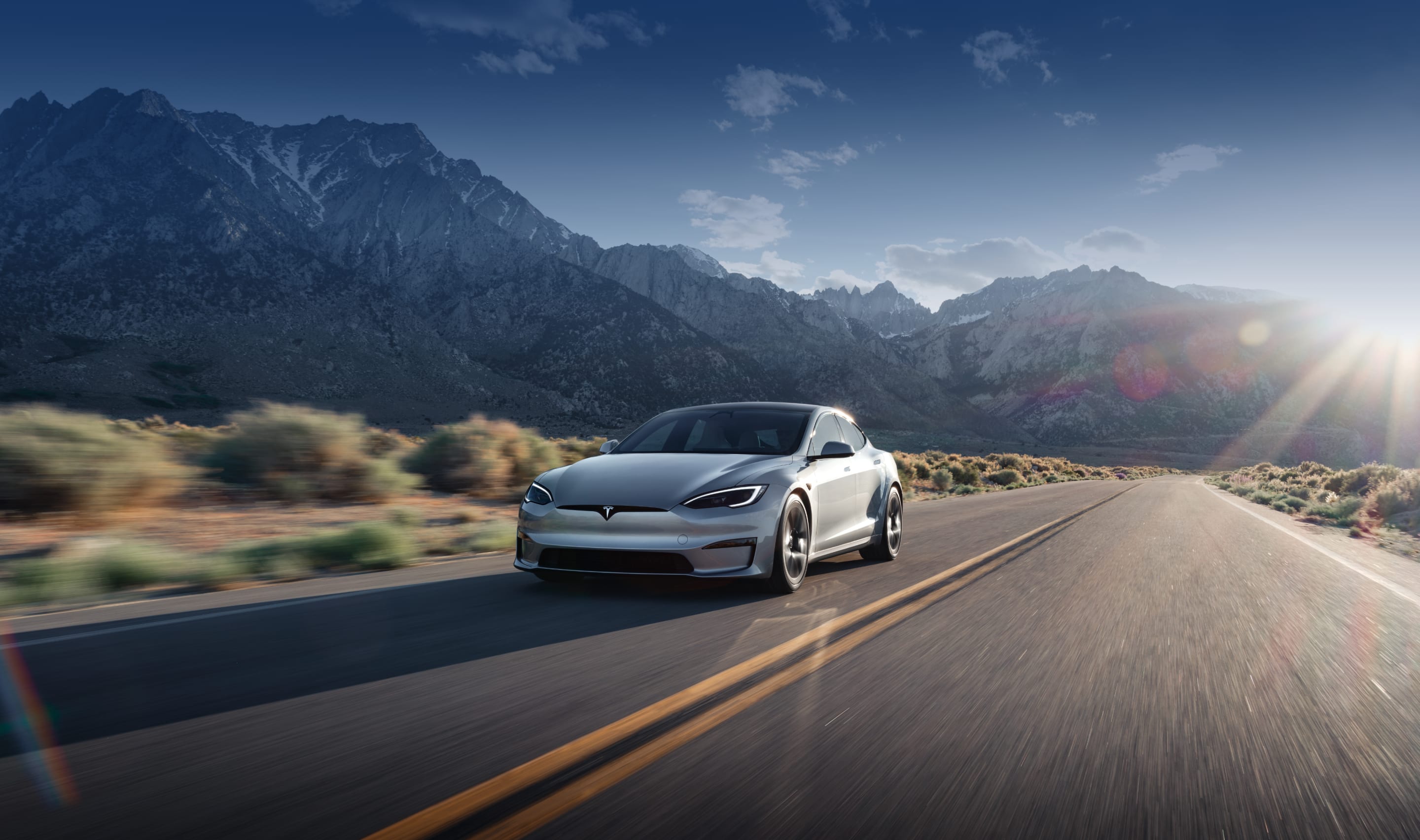 Solid black Model S accelerating on an elevated highway